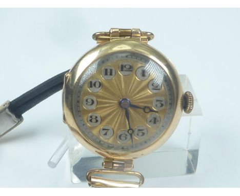 Lady's 9ct gold watch with silvered and engine turned gilt dial..