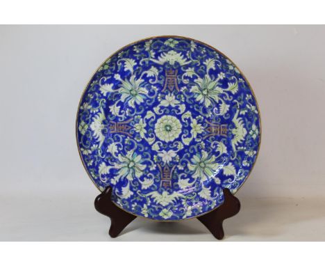 19th century Chinese porcelain plate the blue ground decorated with lotus flowers, lucky bats and four Shou symbols, in white