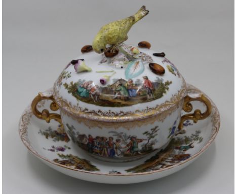 A German porcelain twin handled cup with lid and saucer, bird finial (repair to tail), bearing mark to base, H.18cm W.22cm