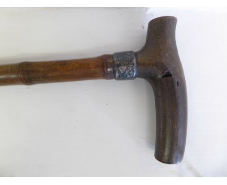 A 19th century rhino horn handled walking cane with silver collar. Note this items is subject to CITIES regulations, buyers o