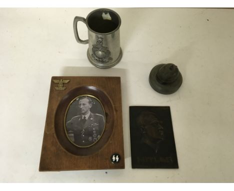 A group of various military oddments to include a bronzed plaque portrait of Adolf Hitler, a framed picture of a German offic