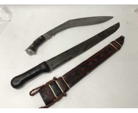 A pair of weapons to include a Kubrick knife and a tribal machete, possibly African - NO RESERVE