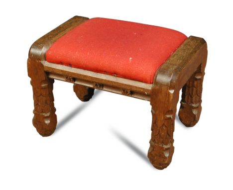 A Puginesque Gothic oak stool, the drop-in seat above rose carved frieze and heavy scale carved legs 36 x 55.50 x 35cm (14 x 