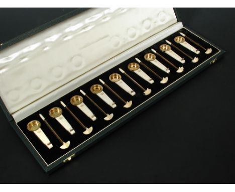 A cased set of nine silver gilt and ivory swizzle sticks and drop dishes by Auguste Leroy et Cie (1912-1935), each embossed i