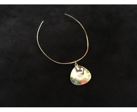 Anni & Bent Knudsen, a silver torque and pendant, the softly shaped and tapering torque with a concave pear shaped disc penda