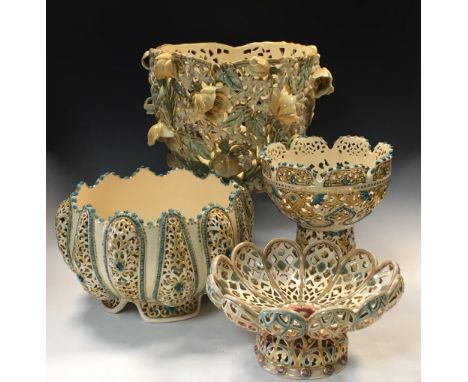 A large Zsolnay reticulated jardiniere, decorated in relief with flower heads, together with another Zsolnay reticulated plan