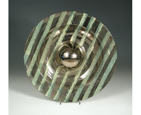 A studio pottery charger by M. Ivey, of dished circular fom with bulbous centre, decorated with silver lustre bands on a marb