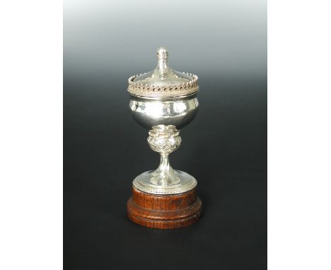 A George V silver pedestal cup, cover and stand by Omar Ramsden, London, 1926, the upswept pull-off cover on an ogée bowl to 