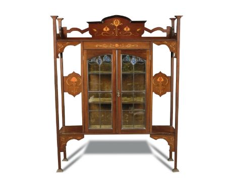 An Art Nouveau mahogany display cabinet by William Twigg, London, with central lead glazed doors, the surround with stylised 