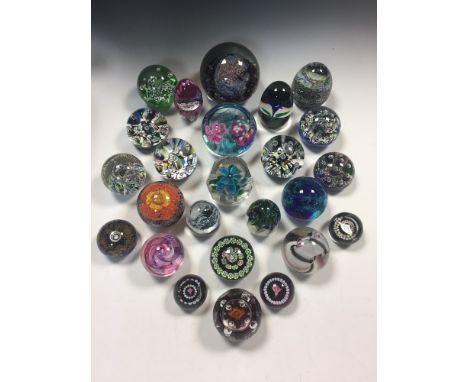 A collection of assorted Scottish glass paperweights, including a Selkirk Charles & Diana commemorative weight, a Selkirk Har