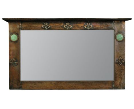 An Arts & Crafts copper and enamel overmantel mirror, the rectangular mirror plate with repoussé copper surround embossed wit