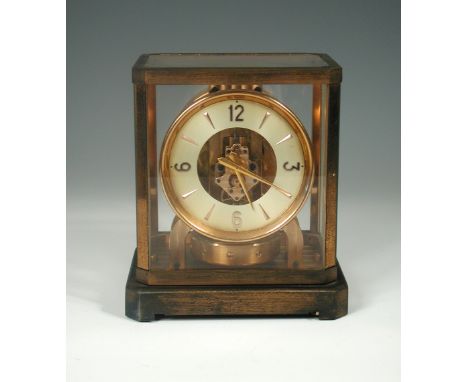 A Jaeger-LeCoultre Atmos clock, no. 61264, circa 1952, of classic design, the gilt case with white chapter ring 22cm (9in)  