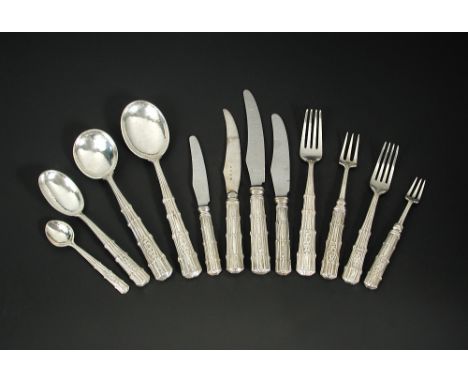 A fourteen-piece suite of Arts & Crafts style silver flatware by Omar Ramsden, London 1932, 1933 and 1934 comprising four gra