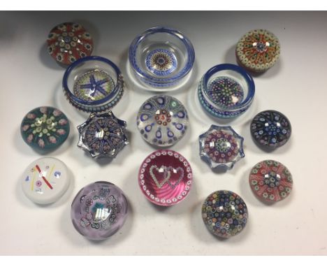 A collection of Scottish glass paperweights, including two spoke design dishes, a Scottish Borders Art Glass facetted weight,