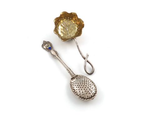 An American parcel-gilt silver tea strainer, by George Shiebler and Co., New York, deep leaf form, with a branch handle, leng