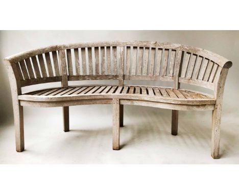 BANANA BENCH, silvering weathered teak of slatted form and bowed outline, 155cm W.