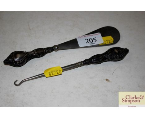 A silver handled button hook and shoe horn 