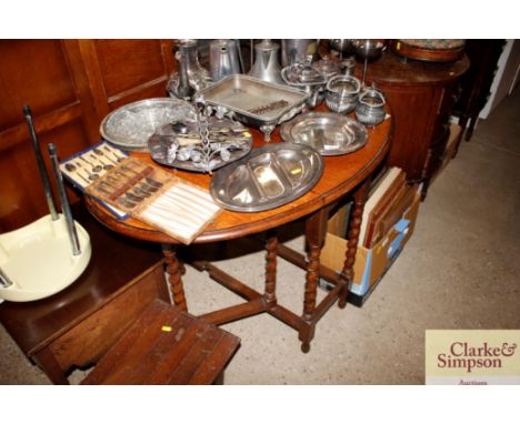 A 1930's oak gate leg tea table on barleytwist supports 