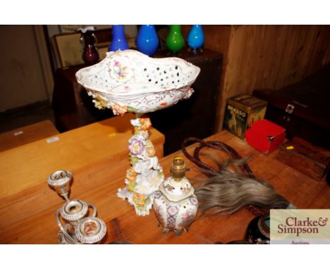 A continental porcelain comport raised on cherub and floral encrusted base; and a porcelain table lamp base AF