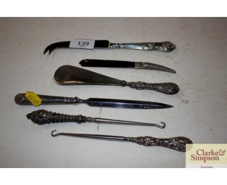 Various silver handled knives shoe horn, paper knives, button hooks etc.
