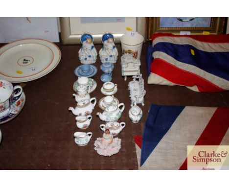 A collection of Coalport and other miniature teaware; a pair of porcelain trinket boxes in the form of seated ladies; a Coron