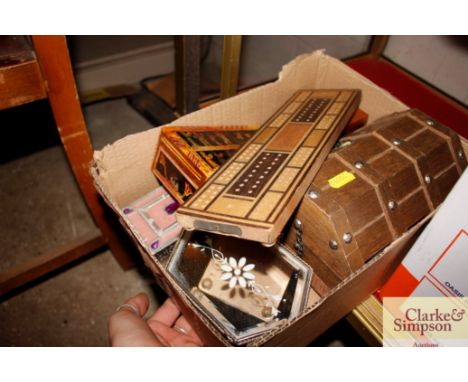 A box containing miscellaneous items to include an inlaid crib board, various trinket boxes etc.