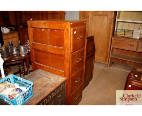 A vintage oak four drawer filing cabinet 