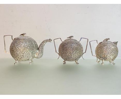 An Indian three piece silver tea service, late 19th century, possibly Oomersi Mawji, (Kutch) but unmarked, each piece of sphe