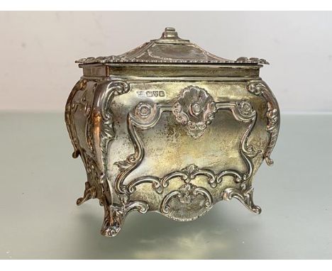 An Edwardian silver tea caddy, George Nathan &amp; Ridley Hayes, Chester 1909, of bombe form, the hinged cover chased with sh