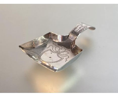 A George III silver caddy spoon, Birmingham 1805, with bright-cut decoration and vacant cartouche to the bowl. 6.5cm