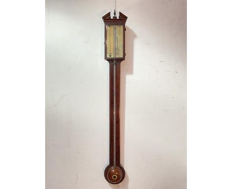 A George III Scottish inlaid mahogany stick barometer, the broken swan-neck pediment centred by a brass finial over a glazed 