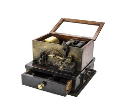 ANNOUNCE THIS LOT IS A RECORDING GALVENOMETER
Morse recorder: in brass and ebonised wood case with hinged glazed lid and elec