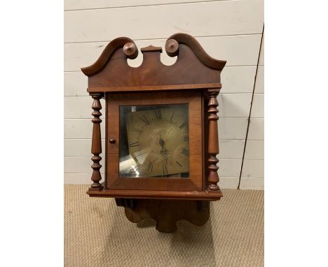 A mahogany cased hooded wall clock 