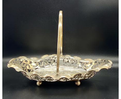 A silver pierced bowl with handle, total weight 415g, hallmarked for Sheffield 1918 by R F Mosley &amp; Co