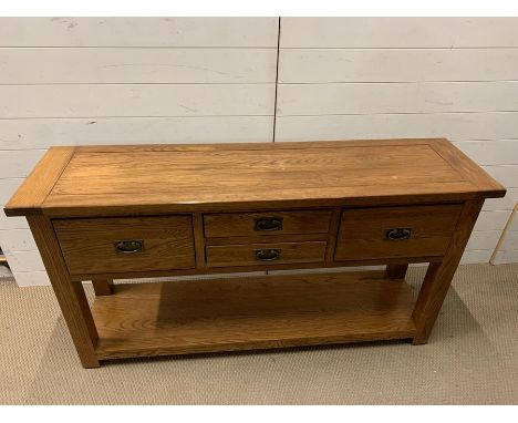 A light oak sideboard with large drawers to ends and two small drawers to centre (H80cm W150cm D40cm)