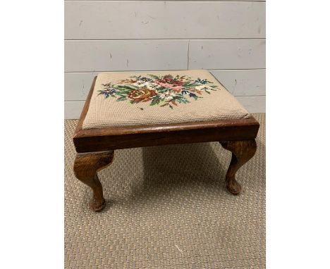 A mahogany foot stool on cabriole legs and tapestry seat pad (H26cm W43cm D38cm)