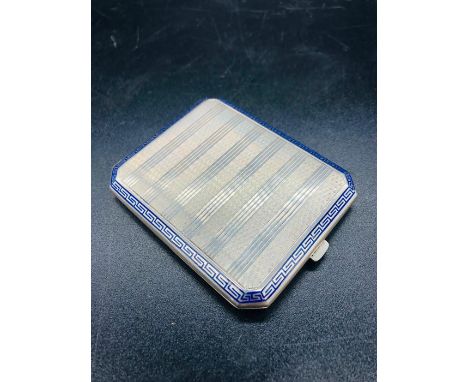A machine tooled and enamel cigarette case with Greek key design