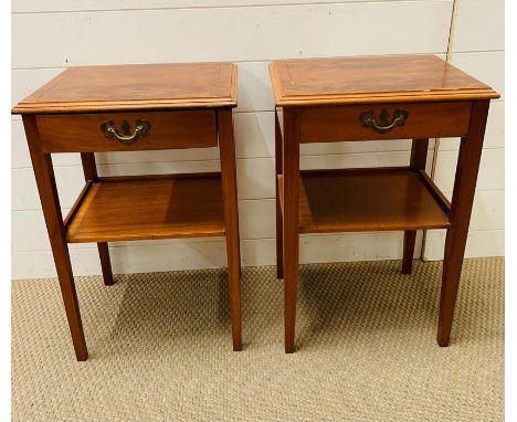 A pair of bedside cabinets with shelf under on square tapered legs 