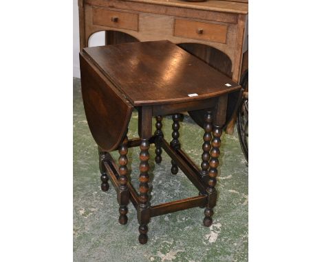 An oak oval gate leg table, bobbin turned legs, c.1930