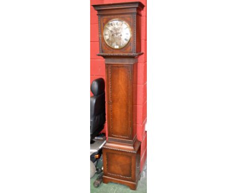 An oak longcase clock, stepped cornice, dot and dash beading, silvered circular dial, Roman numerals, gadrooned border to bas