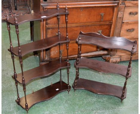 A mahogany four tier wall shelf, serpentine shelves, turned uprights; another, three tier. (2)