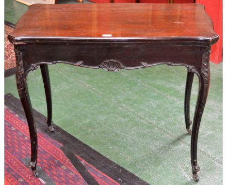 A 19th century mahogany serpentine card table, folding top enclosing an inset baize lined playing surface, counter wells to a