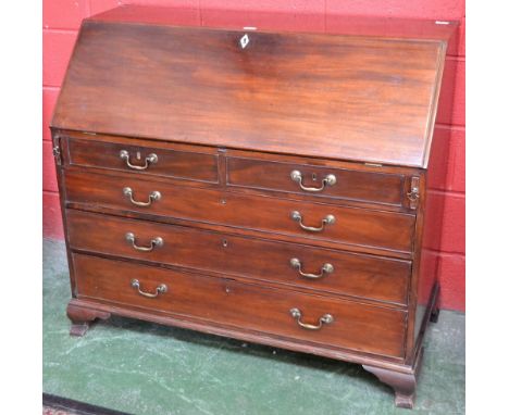 A George III mahogany bureau, fall front enclosing a satinwood veneered arrangement of pigeon holes and small drawers centred