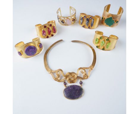 A vibrant collection of 7 gold tone fashion jewelry pieces, including six ornate cuff bracelets adorned with colorful stones 