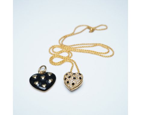 A Joan Rivers locket necklace featuring a gold-tone heart-shaped design adorned with sparkling clear and black crystals. The 