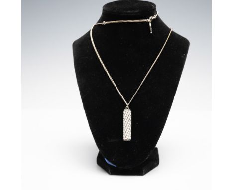 Halcyon Days enamel pendant necklace featuring a cylindrical pendant with a white and black scale-like pattern, suspended fro
