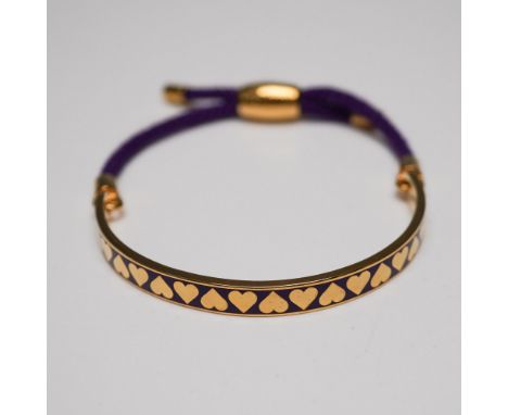 Halcyon Days enamel and cord bracelet featuring a gold-plated half-bangle with a vibrant purple enamel inlay adorned with a r