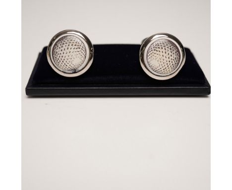 Pair of Halcyon Days enamel and metal cufflinks featuring a golf ball motif encased in a round silver-tone setting. Each cuff