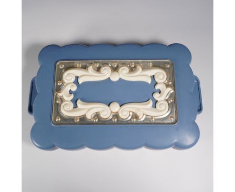 This vintage Max Factor Hollywood Brownette wig case doubles as a cosmetic vanity box, featuring a scalloped-edge blue plasti