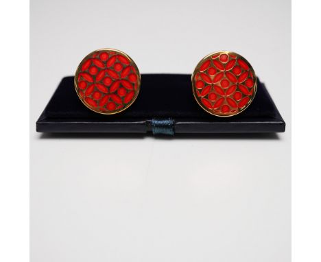 A refined pair of Halcyon Days gold-tone cufflinks featuring a vibrant red enamel design with an intricate geometric pattern.